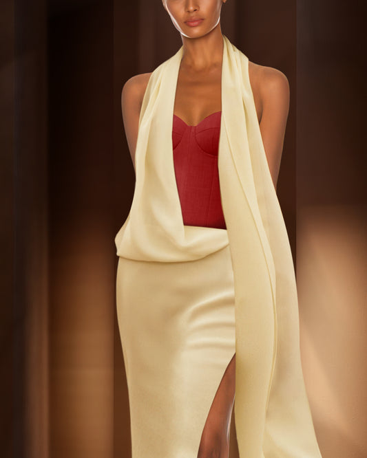Woman wearing a red top and beige skirt with a long beige scarf against a brown background